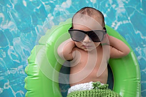 Newborn Baby Boy Floating on a Swim Ring