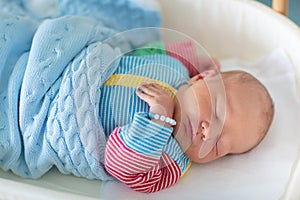 Newborn baby boy in hospital cot