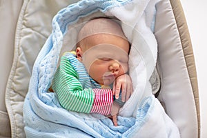 Newborn baby boy in hospital cot