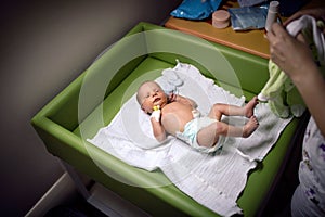 Newborn baby boy in a hospital room bed