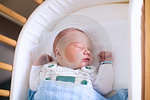 Newborn baby boy in hosptal cot