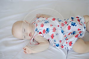 Newborn baby boy lying on bed