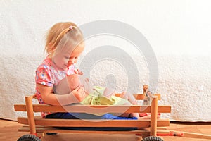 Newborn baby boy lying on little sister