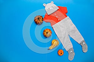 Newborn baby boy set - caps, panties, shirt and toy pumpkins - on a blue background