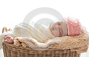 Newborn baby boy sleep on his brown basket relaxing under a whit photo