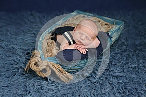 Newborn Baby Boy Sleeping in a Boat