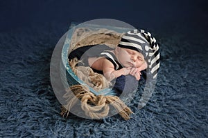 Newborn Baby Boy Sleeping in a Boat