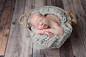 Newborn Baby Boy Sleeping in a Bucket