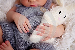 Newborn baby boy, sleeping peacefully in basket, dressed in knit