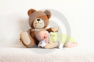 Newborn baby boy sleeping on Teddy bear