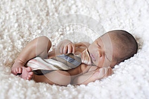 Newborn baby boy sleeping with a tie