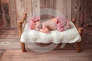 Newborn Baby Boy Sleeping on a Tiny Bed