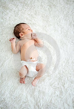 Newborn baby boy sucking his fist