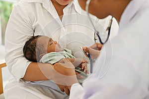 Newborn baby boy visiting the doctor for checkup health