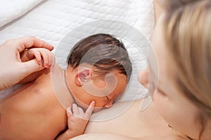 Newborn baby breastfeeding after birth.