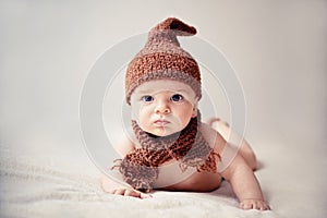 Newborn baby in a cap and scarf