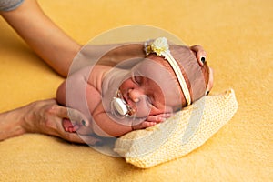 Newborn baby concept photography preparation, cute new born baby back with a bandage on the head