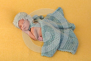 Newborn baby covered with blanket