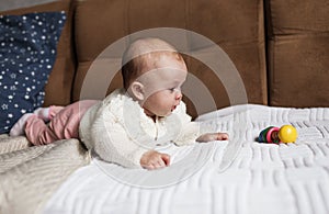 a newborn baby in a crib, the concept of children and the birth of a close-up