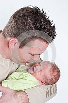 Newborn baby crying in the arms of his papa