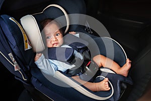 newborn baby crying while sitting in infant car seat, safety chair travelling