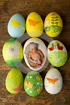 Newborn baby in Easter eggs