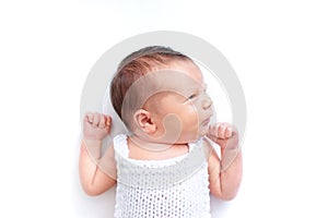 Newborn baby emotions, white background. Funny face of a child, emotions