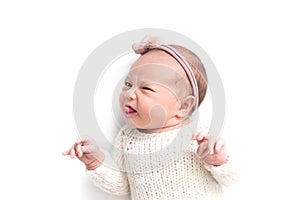 Newborn baby emotions, white background. Funny face of a child, emotions