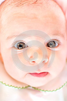 Newborn baby face big eyes soft skin closeup