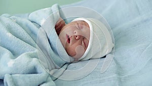 Newborn Baby Face Portrait Acne Allergic Irritations Early Days Sleeping On Blue Background. Child At Start Minutes Of