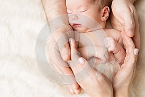 Newborn Baby in Family Hands, Sleeping New Born Kid, Parents Care and Protection Concept