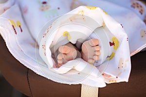 Newborn baby feet, barefoot with tiny toes in selective focus, family and maternity concept. Photo of newborn baby feet.