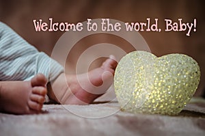 Newborn baby feet in bed close up. Happy Family concept. Beautiful conceptual image of Maternity. Useful as greeting card.