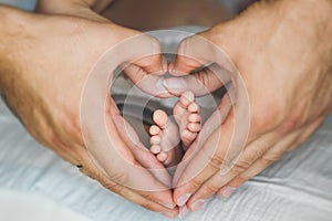 Newborn baby feet in mother hands.