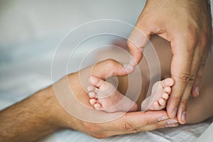 Newborn baby feet in mother hands.