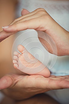 Newborn baby feet in mother hands.