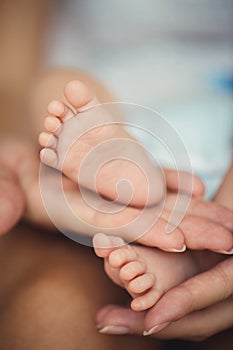 Newborn baby feet in mother hands.