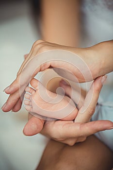 Newborn baby feet in mother hands.