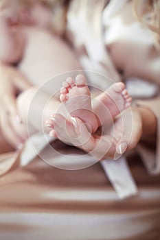 Newborn Baby feet in mother hands closeup