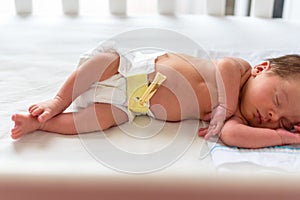 Newborn baby with few days lying in cradle