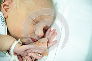 A newborn baby on the first day of its birth in the maternity hospital