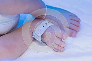 Newborn baby foot with identification hospital tag name