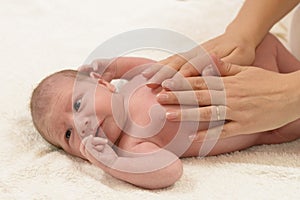 Newborn Baby getting oil massage