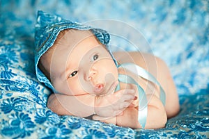 Newborn baby girl in a blue lace bonnet