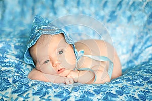 Newborn baby girl in a blue lace bonnet