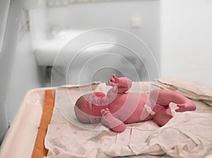 A newborn baby girl cries moments after birth