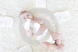 Newborn baby girl with diapers. Dry skin and nursery