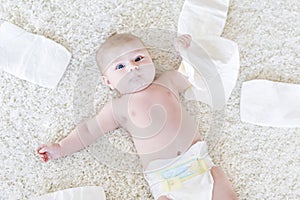 Newborn baby girl with diapers. Dry skin and nursery