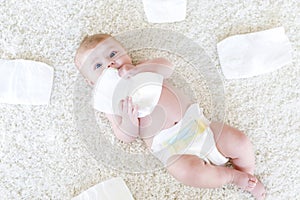 Newborn baby girl with diapers. Dry skin and nursery