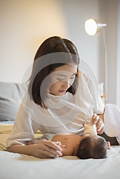 Newborn baby girl is drinking milk by  her mother